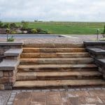 natural stone stairs with paver patio