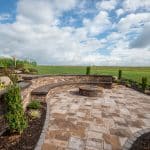 paver patio with firepit and seating wall