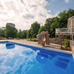 fiberglass swimming pool with paver patio