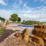 Swimming pool with water feature and patio