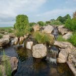 pond off of patio and outdoor living space