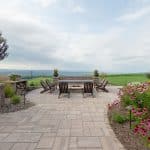 paver patio with fire pit and seating wall with pergola