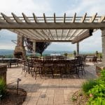 paver patio with fire pit and seating wall with pergola