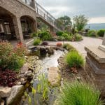 pond off of patio and outdoor living space