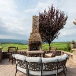 Outdoor fireplace with pergola and paver patio