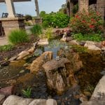 pond off of patio and outdoor living space