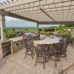 Outdoor fireplace with pergola and paver patio