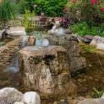 pond off of patio and outdoor living space