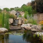 pond off of patio and outdoor living space