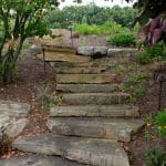 natural stone stairs with landscaping